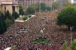 A general view of the opposition protest rally against election fraud outside the Yugoslav parliament building (top left) in Belgrade centre October 5, 2000. Fire raged inside the Yugoslav parliament on Thursday after demonstrators entered the building. Thousands of protesters milled outside the building, part of a vast opposition rally to demand that President Slobodan Milosevic concede electoral defeat. REUTERS/Slobodan Miljevic